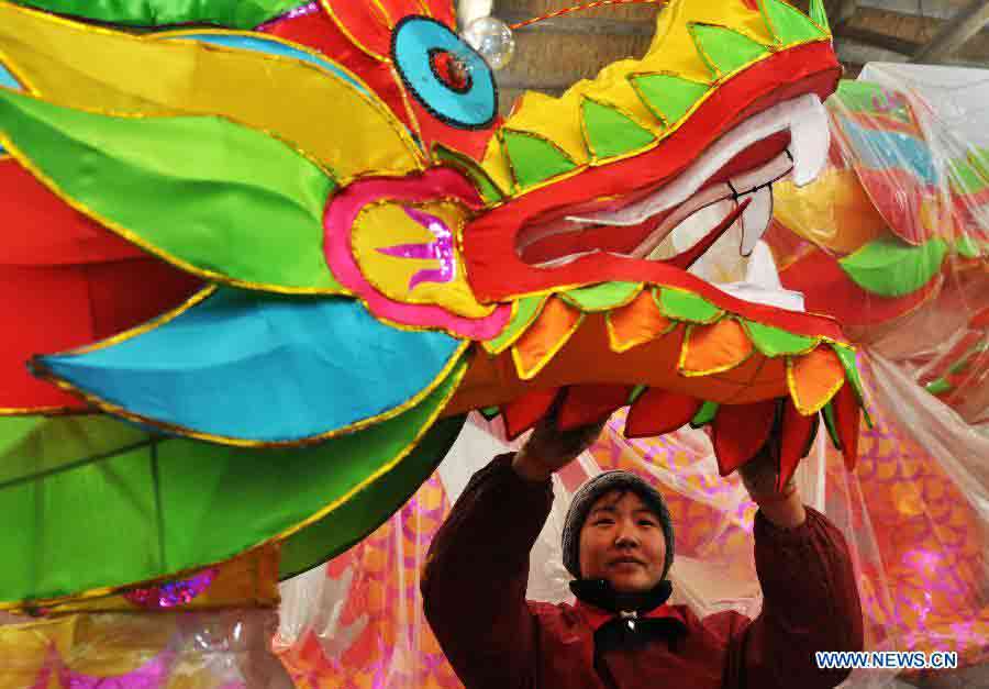 A worker decorates a lantern in a lantern factory in Zhoucun District of Zibo, east China's Shandong Province, Jan. 14, 2013. As traditional Chinese Spring Festival is coming, lantern factories here have come to a busy production season. (Xinhua/Dong Naide)