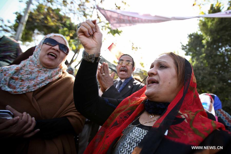 Anti-Morsi protesters shout slogans against the constitution in front of the Supreme Constitutional Court (SCC) in Cairo, Egypt, Jan. 15, 2013. Egyptian Supreme Constitutional Court is set to review Tuesday lawsuits against the Shura Council (upper house of the parliament) which currently assumes legislative power, as well as the dissolved Constituent Assembly which wrote the recently approved constitution. (Xinhua/Amru Salahuddien) 