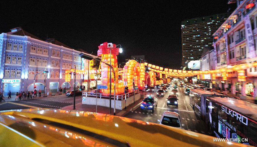 Picture taken on Jan. 15, 2013 shows a 128-meter-long snake-like red lantern between New Bridge Road and Eu Tong Sen Road in Singapore. The New Year lanterns lit up first time for preview on Tuesday. (Xinhua/Then Chih Wey)