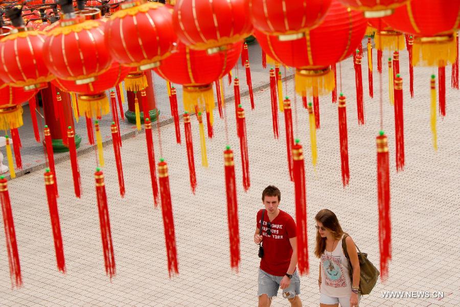 Visitors walk pass red lanterns in Thean Hou Temple in Kuala Lumpur, capital of Malaysia, on Jan. 7, 2013. Red lanterns are decorated to greet the upcoming Chinese Lunar New Year, Year of the Snake. (Xinhua/Chong Voon Chung) 