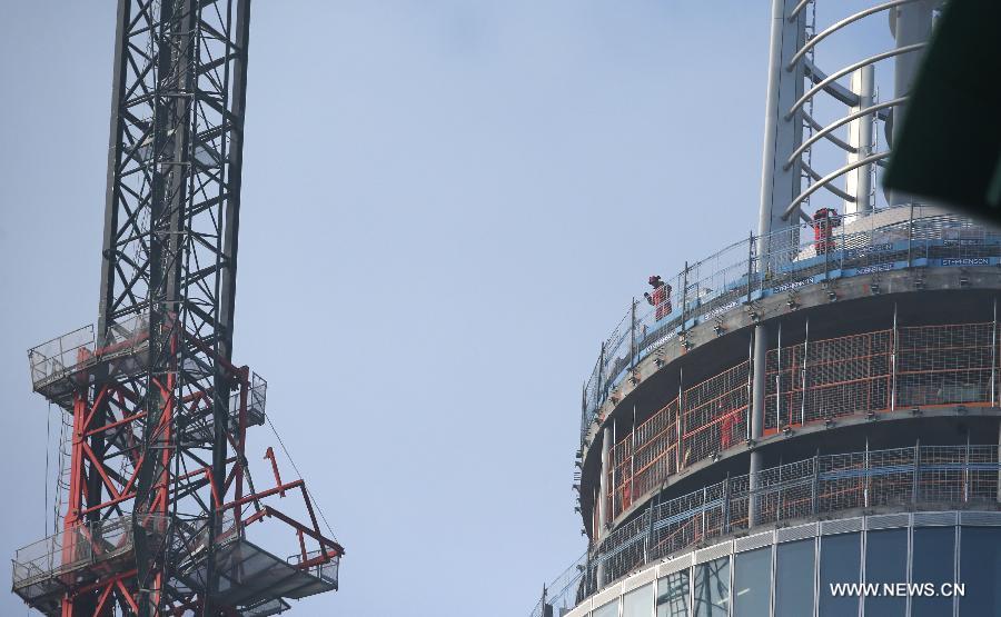 Rescue workers inspect the damaged crane at the scene of a helicopter crash in central London, Britain, Jan. 16, 2013. Two people were killed and another two were injured after a helicopter crashed into a construction crane near Wandsworth Road, south of River Thames in central London earlier on Wednesday. (Xinhua/Yin Gang)