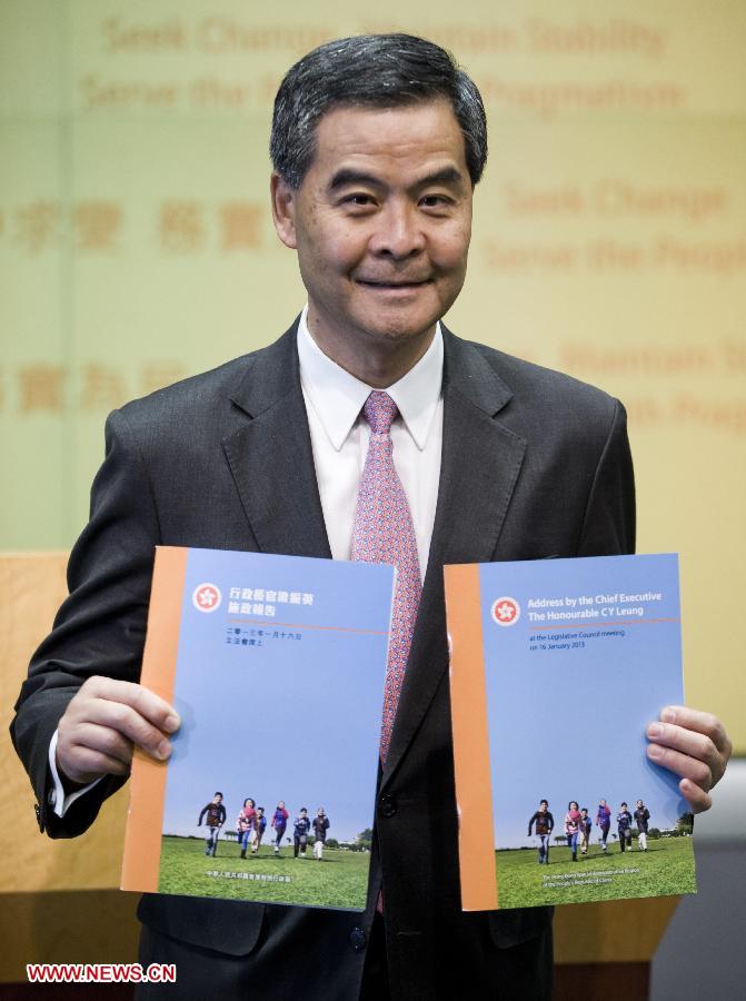 Hong Kong Chief Executive Leung Chun-Ying poses with the print version of his 2013 Policy Address at a press conference in Hong Kong, south China, Jan. 16, 2013. Leung delivered his first policy address on Wednesday morning at the Legislative Council here, outlining the city government's policy direction in 2013. (Xinhua/Lui Siu Wai)