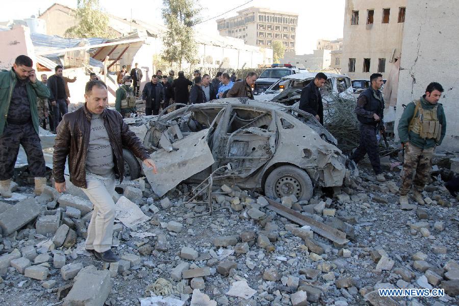 The site of a bomb attack is seen in Kirkuk, Iraq, on Jan. 16, 2013. Up to 17 people were killed and 133 wounded in two bomb attacks targeting offices of Kurdish parties in the ethnically mixed cities of Kirkuk and Tuz-Khurmato in northern Iraq on Wednesday, according to the police. (Xinhua/Dina Assad)