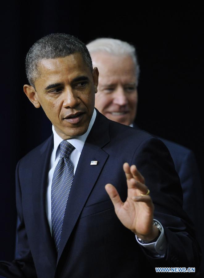 U.S. President Barack Obama and Vice President Joe Biden attend an event on gun violence reduction proposals at the White House in Washington D.C., capital of the United States, Jan. 16, 2013. Obama on Wednesday unveiled a sweeping and expansive package of gun violence reduction proposals, a month after the Sandy Hook Elementary School mass shooting killed 26 people including 20 schoolchildren. (Xinhua/Zhang Jun)