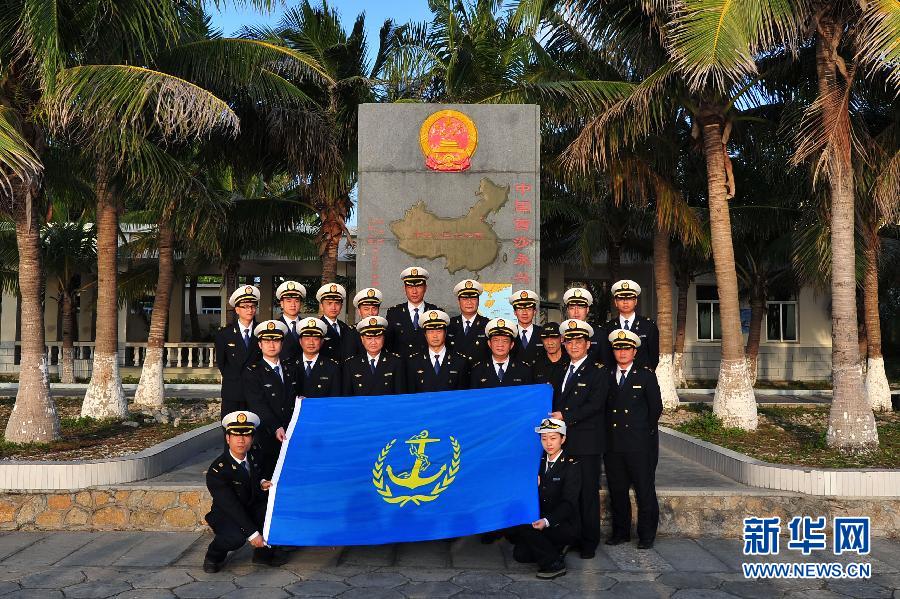 The crew members of marine patrol ship "Haixun 21" take photos at Yongxing Island on Jan. 16, 2013. (Xinhua/Hou Jiansen)