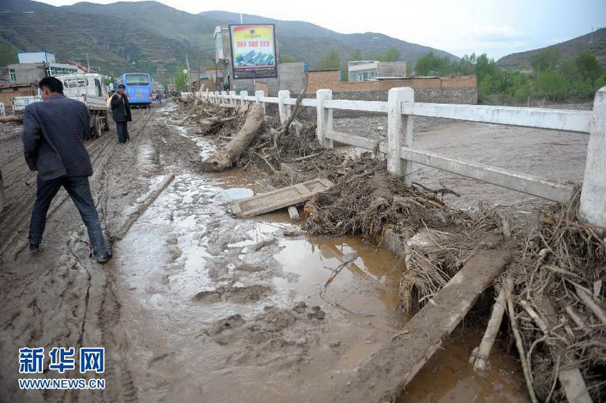 The Eryang River flows past under a bridge in national road 212. Large amount of garbage blocked the aperture of the bridge, forcing water flow back to hit the Chashu town, causing significant losses on May 12 2012. Hail and torrential rain pounded Gansu province two days earlier, bringing b huge losses. (Xinhua/Nie Jianjiang)