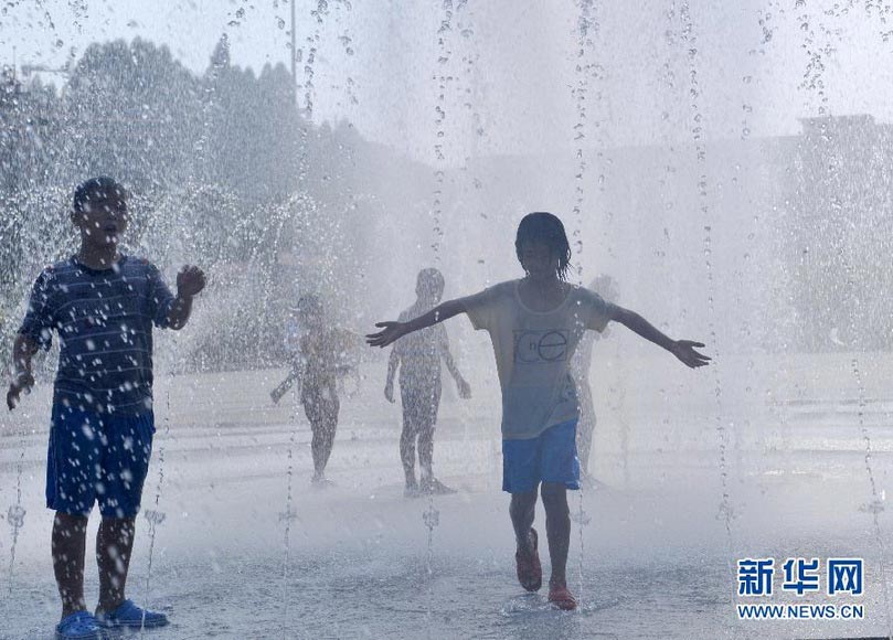 Children play in a fountain to relive summer heat in Songhe Park in Guangxi on Aug. 2, 2012. Summer heat wave continued to hit Guangxi and the temperature rose to 38 degrees Celsius from Aug 1, 2012. (Xinhua/ Zhou Hua)