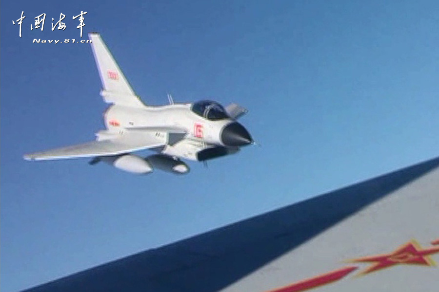 A flight delegation of China's naval air force conducts a long-range raid exercise, and they shoot down the simulated "enemy aircraft" during the exercise. The exercise marked a new breakthrough in their precision raid and actual combat capability. (navy.81.cn/Li Ronglei, Wang Zhenbing)