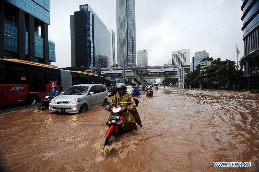 A motorcyclist wades through flood waters in Jakarta, Indonesia, Jan. 17, 2013. The Indonesian capital city of Jakarta was paralyzed by flood on Thursday following a massive downpour since Wednesday night, with its main roads inundated, public transport disrupted and operation of government offices and private sector coming to a standstill. (Xinhua/Veri Sanovri)