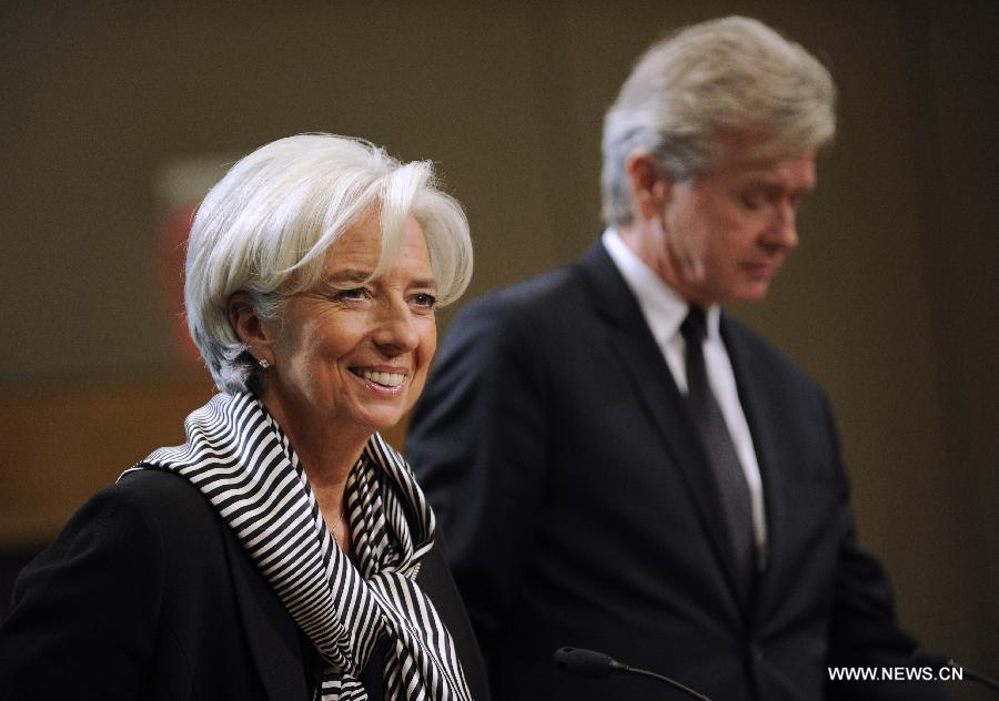 Managing Director of the International Monetary Fund (IMF) Christine Lagarde (L) attends a news conference on the outlook of global economy in 2013 in Washington D.C., Jan. 17, 2013. There is a lot of work left to do to bolster global economic recovery despite some important steps taken in key economies to reduce financial and fiscal risks, Christine Lagarde said here on Thursday. (Xinhua/Wang Yiou) 