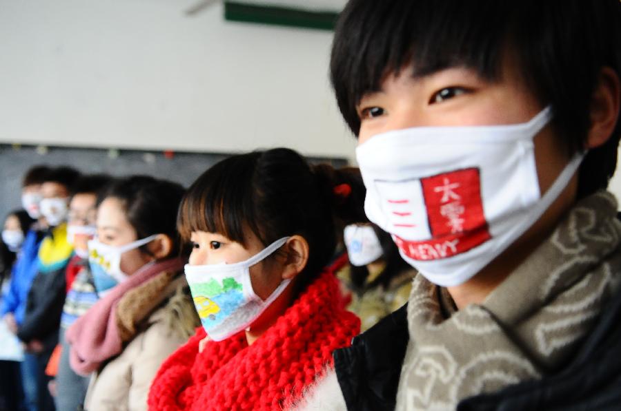 Students from the School of Fine Art of Liaocheng University present self-designed masks in Liaocheng, east China's Shandong Province, Jan. 17, 2013. A competition for mask design was held in the school to promote the ideal of environment protection and a low-carbon lifestyle. (Xinhua/Zhang Zhenxiang) 