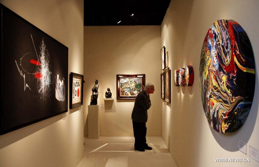 A visitor visits at the 58th Brussels Antiques & Fine Arts Fair (BRAFA) in Brussels, Belgium, Jan. 19, 2013. A total of 128 antique and fine art dealers from across the world will showcase their most precious pieces of art during the one-week fair. (Xinhua/Wang Xiaojun) 