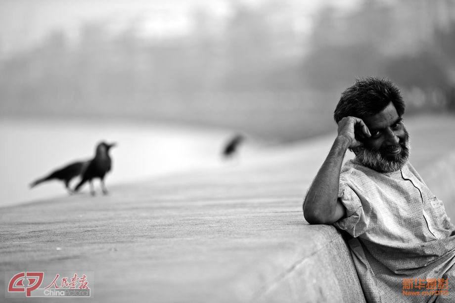 Photo shows an old man who enjoys the sunshine in a weekend’s morning in Mumbai. (Chinapictorial/ Duan Wei)