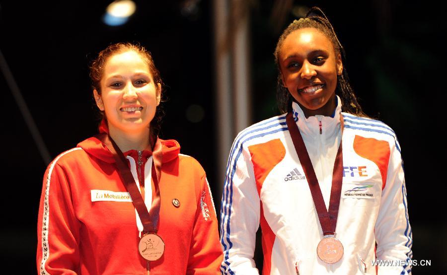 Bronze medalists Tiffany Geroudet (L) of Swizterland and Lauren Rembi of France pose during the awarding ceremony for the women's epee at the Grand Prix of Qatar in Doha, Jan. 20, 2013. (Xinhua/Chen Shaojin) 