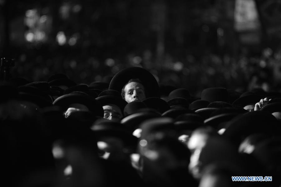 Thousands of Ultra-Orthodox Jews take part in a rally to welcome visiting Grand Rabbi of the Satmar hassidic dynasty Rabbi Zalman Leib Teitelbaum from the United States in Jerusalem's ultra-Orthodox neighborhood of Mea Shearim on Jan. 20, 2013. (Xinhua/Yin Dongxun) 