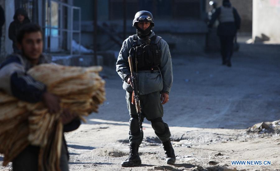 An Afghan policeman stands guard near the Kabul traffic police headquarters during militants attack, in Kabul, Afghanistan, Jan. 21, 2013. Operations against Taliban gunmen who seized a traffic police facility in western Kabul ended Monday afternoon, with all the militants having been killed, the Kabul police chief said. (Xinhua/Ahmad Massoud)