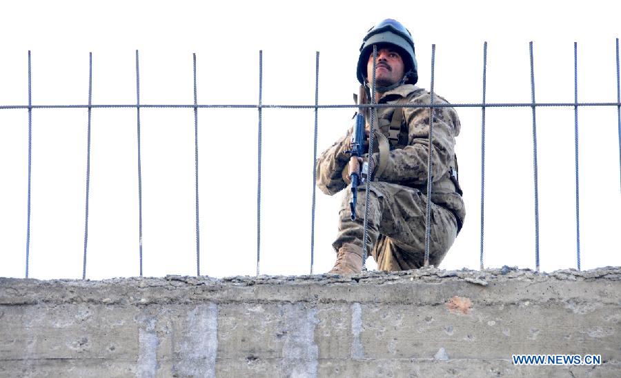 A member of Afghan security force takes position near the Kabul traffic police headquarters during militants attack, in Kabul, Afghanistan, Jan. 21, 2013. Operations against Taliban gunmen who seized a traffic police facility in western Kabul ended Monday afternoon, with all the militants having been killed, the Kabul police chief said. (Xinhua/Ahmad Massoud)