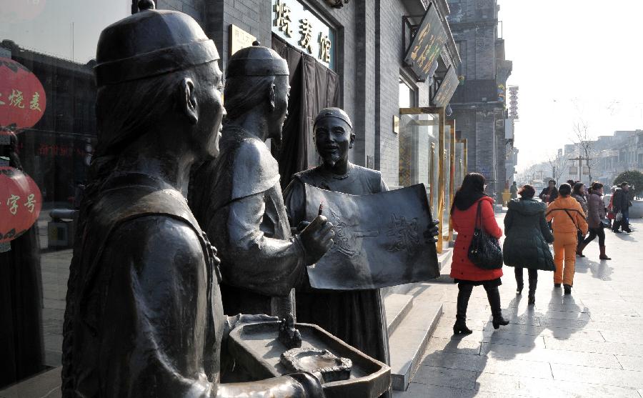 Sculptures are seen along the Qianmen Street in Beijing, capital of China, Jan. 21, 2013. (Xinhua/Li Xin) 