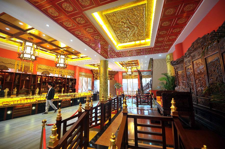 Photo taken on Jan. 21, 2013 shows a shop selling craftworks made of yellow rosewood in a Qilou building in Haikou, capital of south China's Hainan Province. (Xinhua/Guo Cheng) 