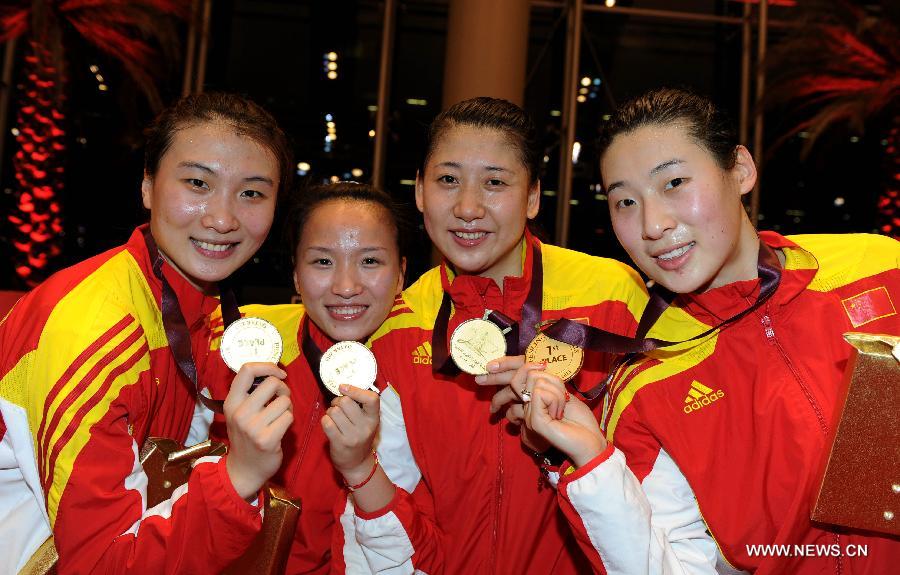 Xu Anqi, Tang Yiling, Yin Mingfang and Sun Yujie (from L to R) of team China pose after the awarding ceremony for the women's epee team final at the Fencing Grand Prix and World Cup in Doha, Jan. 21, 2013. Team China defeated team Estonia to claim the title. (Xinhua/Chen Shaojin) 