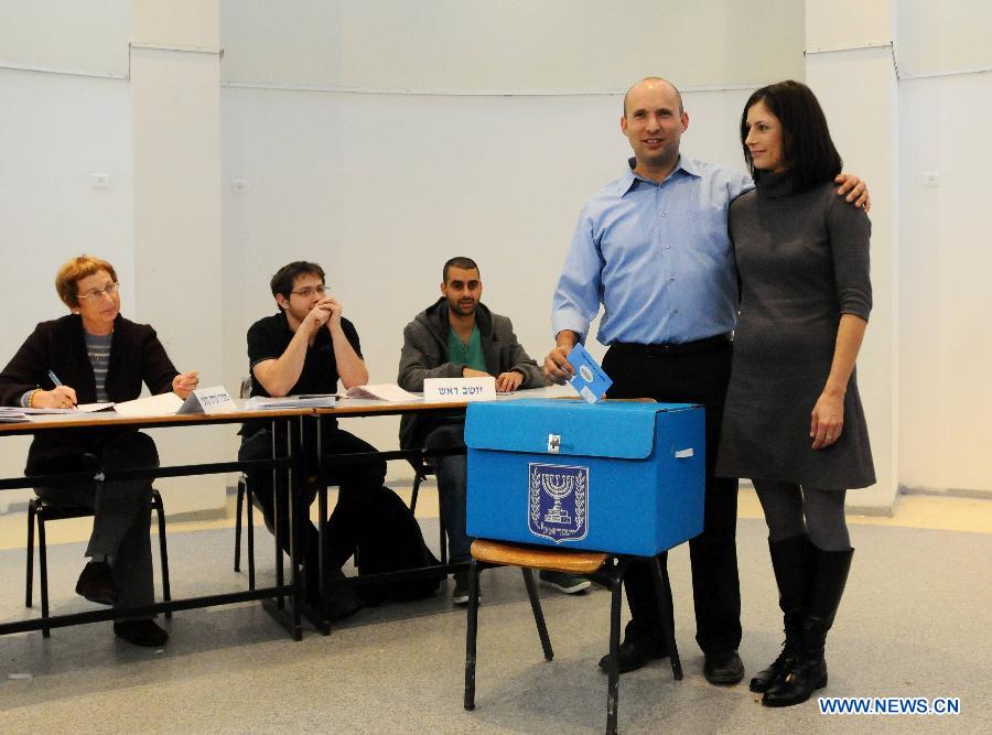 Naftali Bennett, leader of the Bayit Yehudi party (Jewish Home), casts his ballot with his wife at a polling station in Raanana, central Israel, on Jan. 22, 2013. Israel held parliamentary election on Tuesday. (Xinhua/Jini)