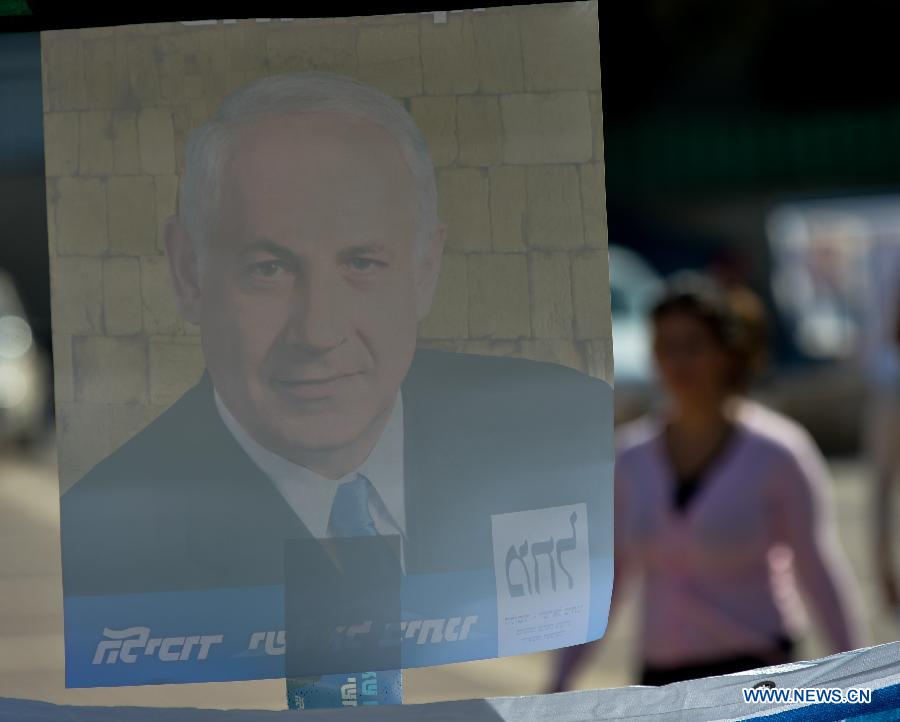 An Israeli passes by an election campaign poster of Israeli Prime Minister and the leader of Likud, Benjamin Netanyahu in Jewish settlement Maale Adumin in the West Bank, Jan. 22, 2013. Israel held parliamentary election on Tuesday.(Xinhua/Yin Dongxun)