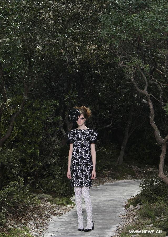 A model presents a creation by German designer Karl Lagerfeld for French fashion house Chanel during the Haute Couture Spring-Summer 2013 collection shows in Paris, France, Jan. 22, 2013. (Xinhua/Gao Jing) 