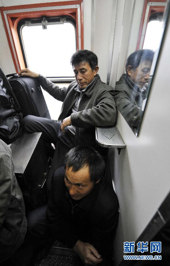 Pu Dagang (above) and his fellow huddle in a corner of the carriage, Jan. 17, 2013. Before reaching home, Pu had to stay on the overcrowded train for more than 30 hours and then travel by coach for another five hours. Although he had to stand almost all the way, Pu felt lucky enough. “It’s better than being far away from home,” Pu said. (Photo/Xinhua)