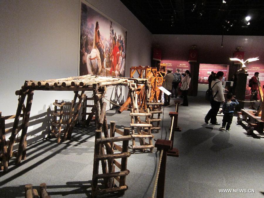 Visitors watch the ancient Rome-related exhibits during an exhibition at Hong Kong Science Museum in south China's Hong Kong, Jan. 23, 2013. Exhibition "Julius Caesar - Military Genius and Mighty Machines" is underway at the Hong Kong Science Museum. More than 40 exhibits reflecting the science and technology of ancient Romans were displayed on the show. (Xinhua/Zhao Yusi) 