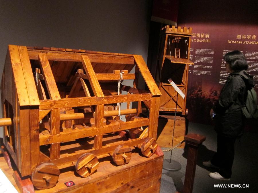 A visitor reads the introduction of the model of a Rome siege weapon during an exhibition at Hong Kong Science Museum in south China's Hong Kong, Jan. 23, 2013. Exhibition "Julius Caesar - Military Genius and Mighty Machines" is underway at the Hong Kong Science Museum. More than 40 exhibits reflecting the science and technology of ancient Romans were displayed on the show. (Xinhua/Zhao Yusi) 