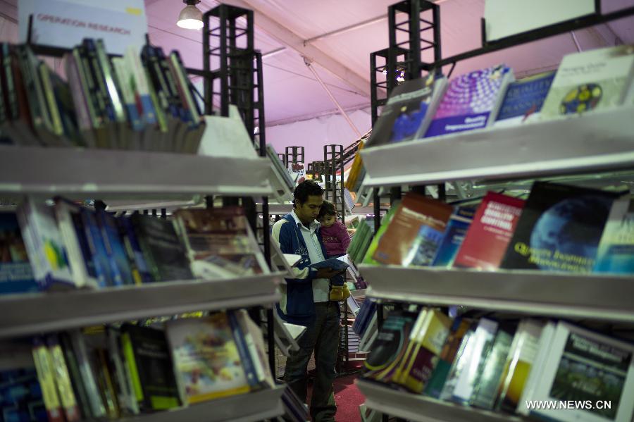 A man reads a book during the 44th Cairo International Book Fair in Cairo, Egypt, Jan. 23, 2013. (Xinhua/Qin Haishi)