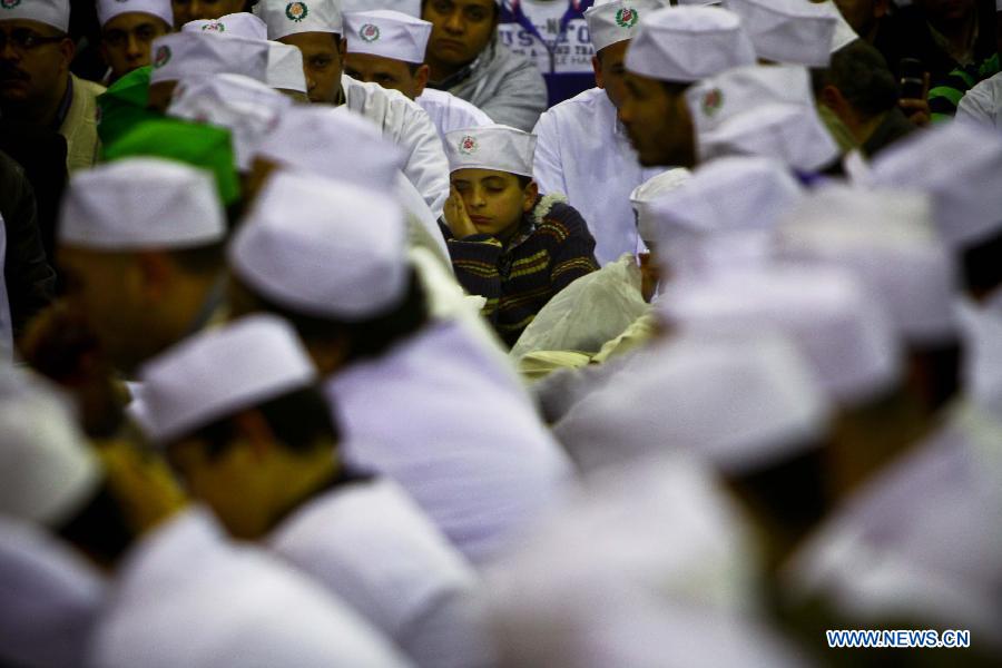 An Egyptian boy sleeps as hundreds of Sufi Muslims take part in sufi celebration rituals to celebrate the birth of Prophet Mohammed, at Al-Hussein mosque in Cairo, Egypt, Jan. 24, 2013. Hundreds of millions of Muslims celebrated the anniversary of Prophet Muhammad's birth all over the world. (Xinhua/Amru Salahuddien)