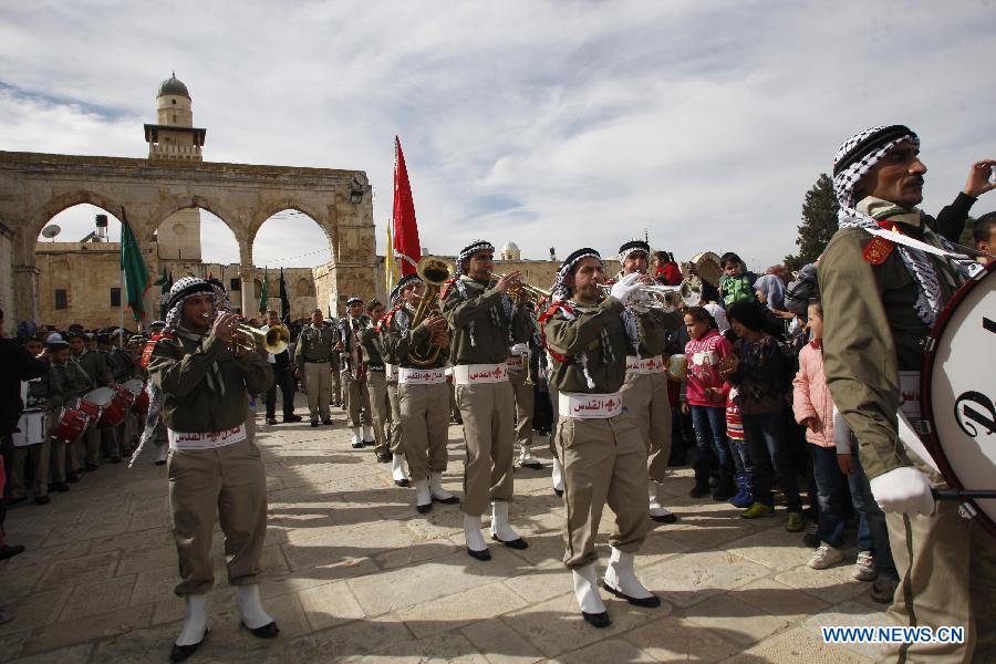 Palestinians take part in a ceremony commemorating the birth of Prophet Mohammed, known in Arabic as "Mawlid al-Nabawi" outside the Dome of the Rock the Al-Aqsa mosque compound, Islam's third holiest site, in the old city of Jerusalem Jan. 24, 2013.(Xinhua/Muammar Awad)