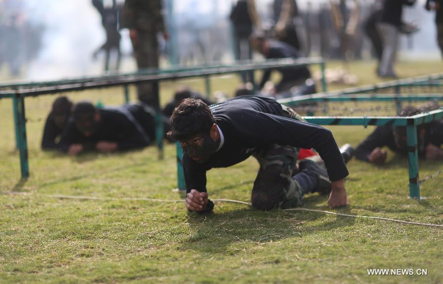 Palestinian high school students show their skills during a graduation ceremony of a military school course organized by the Hamas security forces and the Hamas Minister of Education in Gaza City, on Jan. 24, 2013. (Xinhua/Wissam Nassar)  