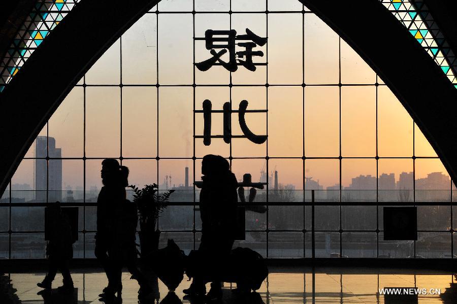 Passengers enter the Yinchuan Railway Station in Yinchuan, capital of northwest China's Ningxia Hui Autonomous Region, Jan. 26, 2013. The 40-day Spring Festival travel rush started on Saturday. The Spring Festival, which falls on Feb. 10 this year, is traditionally the most important holiday of the Chinese people. It is a custom for families to reunite in the holiday, a factor that has led to massive seasonal travel rushes in recent years as more Chinese leave their hometowns to seek work elsewhere. Public transportation is expected to accommodate about 3.41 billion travelers nationwide during the holiday, including 225 million railway passengers, (Xinhua/Peng Zhaozhi)  