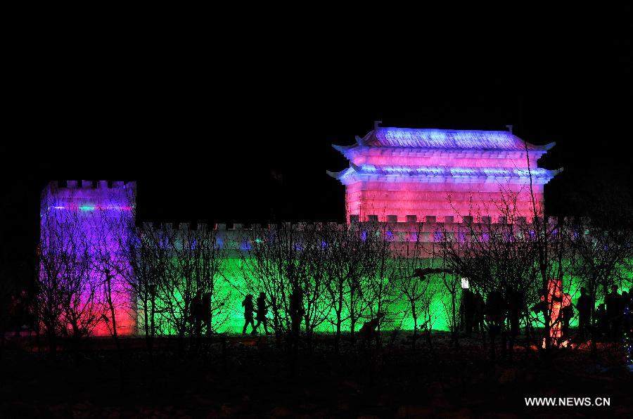 Local residents view an ice sculpture on display at an ice and lantern art festival in Hengcheng scenic spot of Yinchuan, capital of northwest China's Ningxia Hui Autonomous Region, Jan. 25, 2013. The festival kicked off here on Friday. (Xinhua/Peng Zhaozhi) 