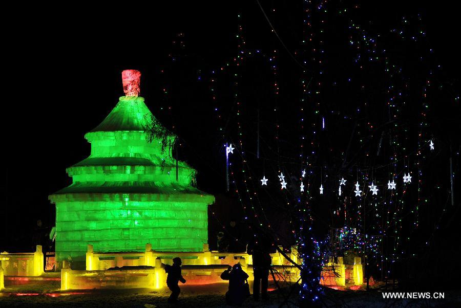 Local residents view an ice sculpture on display at an ice and lantern art festival in Hengcheng scenic spot of Yinchuan, capital of northwest China's Ningxia Hui Autonomous Region, Jan. 25, 2013. The festival kicked off here on Friday. (Xinhua/Peng Zhaozhi) 