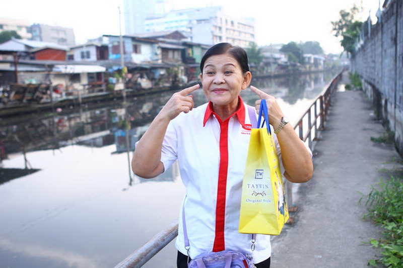 A woman makes faces as she strolls through Bangkok, the capital of the ancient kingdom.