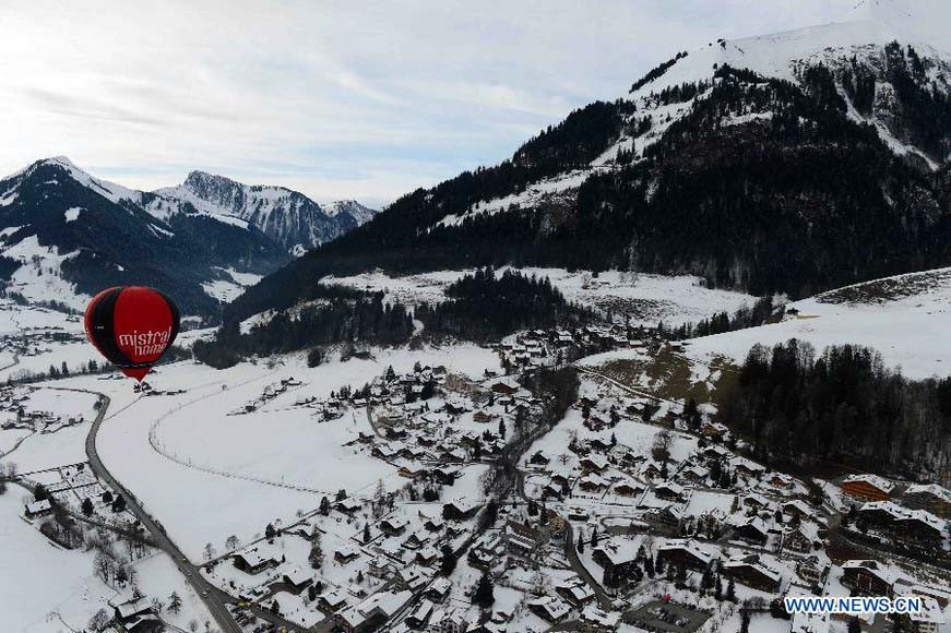 A balloon flies over Chateau-d'Oex, Switzerland, Jan. 26, 2013. The 9-day 35th International Balloon Festival kicked off here on Saturday with the participation of over 80 balloons from 15 countries and regions. (Xinhua/Wang Siwei) 