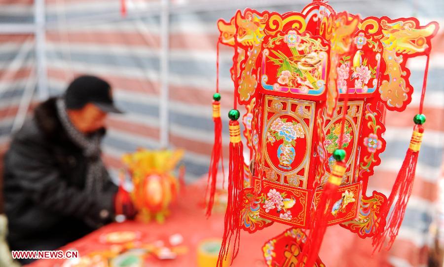 A man makes paper-lanterns at a market in Shijiazhuang, capital of north China's Hebei Province, Jan. 27, 2013. The market offers local customers goods and supplies for the coming Spring Festival which falls on Feb. 10 this year.(Xinhua/Zhu Xudong)