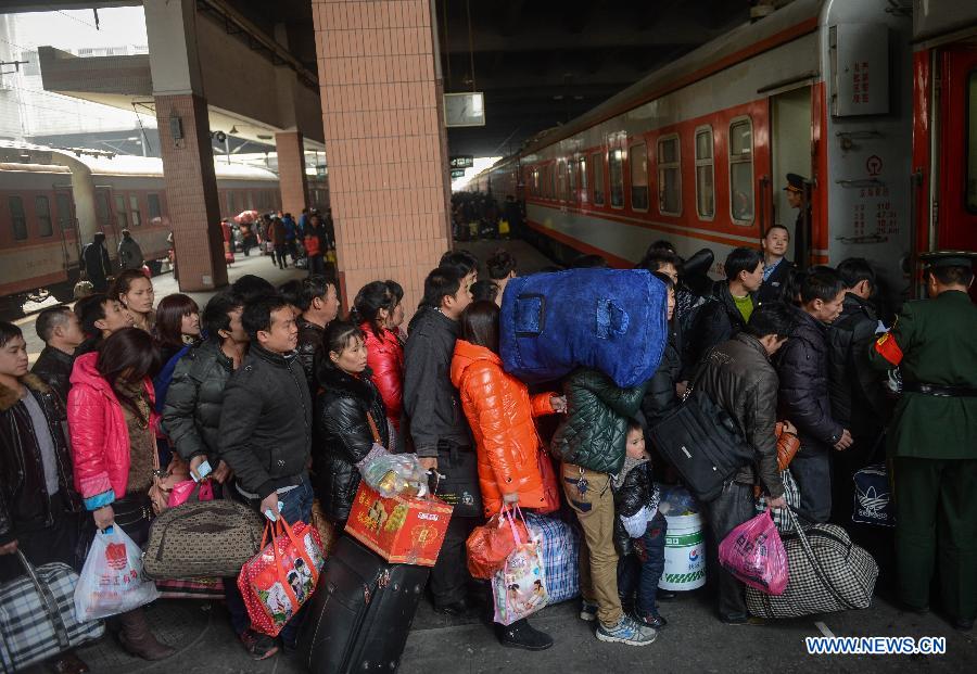 Passengers board a train from Hangzhou to Guiyang, capital of southwest China's Guizhou Province, at Hangzhou train station in Hangzhou, capital of east China's Zhejiang Province, Jan. 27, 2013. The 40-day Spring Festival travel rush began on Saturday. The Spring Festival, the most important occasion for a family reunion for the Chinese people, falls on the first day of the first month of the traditional Chinese lunar calendar, or Feb. 10 this year. (Xinhua/Han Chuanhao)