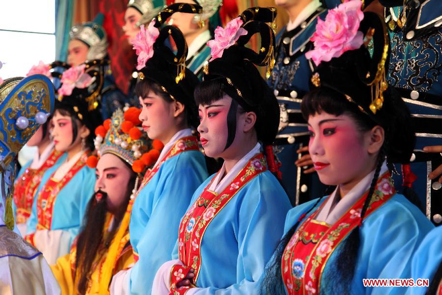 Actors perform Puxian opera, one of the oldest forms of Chinese opera, at the Dongqin Village in Putian City, southeast China's Fujian Province, Jan. 26, 2013. Puxian opera, which originated from puppet shows, has been listed as a national intangible cultural heritage. (Xinhua/Lin Jianbing)