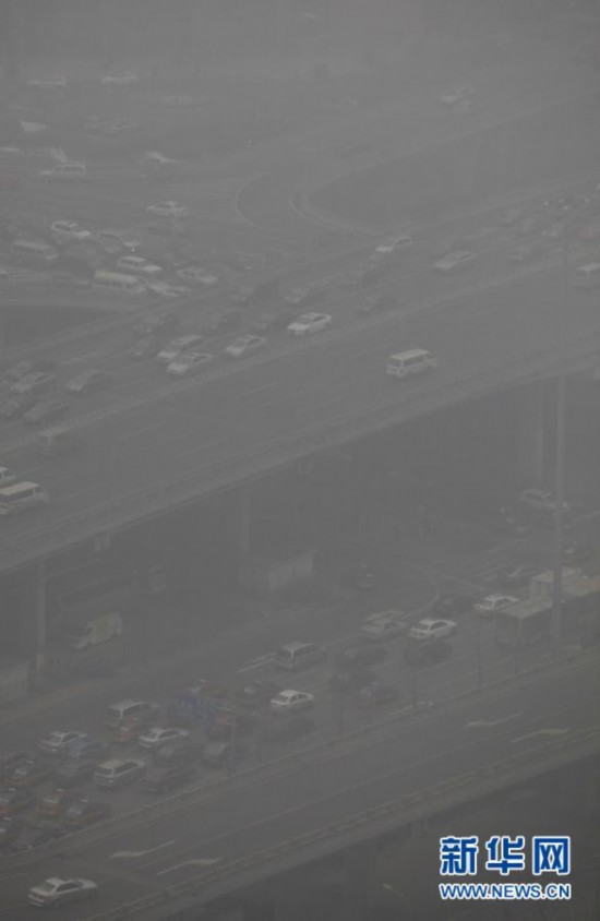 A photo taken on Jan. 23 shows the foggy landscape of the Central Business District in Beijing. Beijing's meteorological center on Monday issued a yellow-coded alert for haze as the fourth foggy weather in this month hit the city and cuts the visibility below 3,000 meters in major parts of Beijing. (Photo/Xinhua)