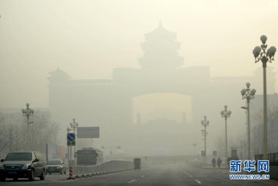 The Beijing West Railway Station looms in the dense fog, Jan. 12. Beijing's meteorological center on Monday issued a yellow-coded alert for haze as the fourth foggy weather in this month hit the city and cuts the visibility below 3,000 meters in major parts of Beijing. (Photo/Xinhua)