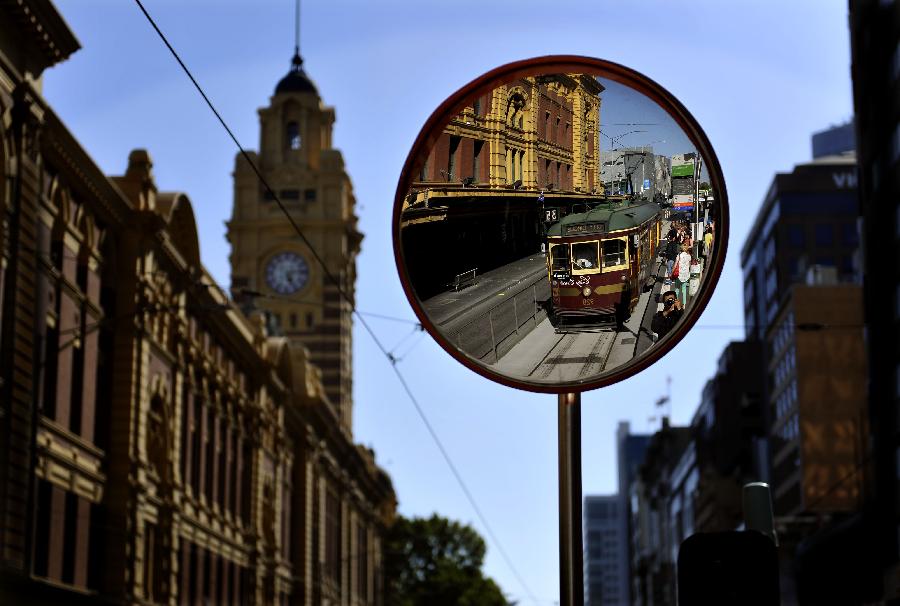 A tram passes by the Flinders Station in Melbourne, Australia, Jan. 28, 2013. Melbourne's trams network is one of the largest functioning tram networks in the world. Among all the routes, No. 35, the City Circle Tram provides a free and convenient way for visitors to see the sights of central Melbourne while experiencing a ride on one of the city's much loved heritage trams. (Xinhua/Chen Xiaowei)