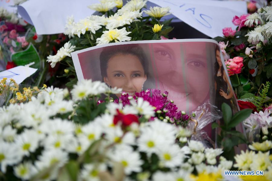 A photo of a victim is seen in front of the Kiss nightclub in Santa Maria, Brazil, Jan. 29, 2013. A total of 231 people died in a fire that swept through a nightclub in the city of Santa Maria, in Rio Grande do Sul state, southern Brazil Saturday night. (Xinhua/Weng Xinyang)