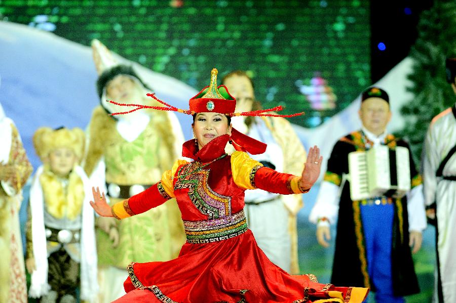 Actors perform in stage play Snowland Families in Altay, northwest China's Xinjiang Uygur Autonomous Region, Jan. 29, 2013. The stage play, created and performed by Altay Art Troupe, tells stories along the ancient Silk Road. (Xinhua/Sadat)