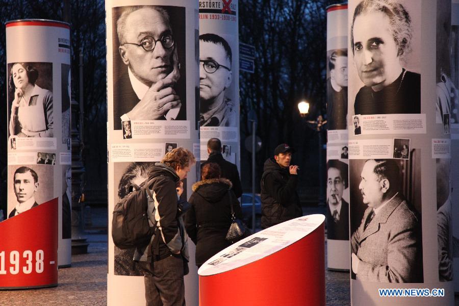 Visitors view the "Diversity Destroyed, Berlin 1933, 1938, 1945" outdoor exhibition in Berlin, Germany, Jan. 29, 2013. The exhibition features portraits of prominent figures in the field of science, artistic and cultural sphere, who were prosecuted by and suffered from the Nazi regime's cruelty dated back to 1933 until 1945. Berlin Municipality kicks off a series of exhibitions, to remind of the 80th anniversary of Adolf Hitler's usurpation of German power on January 30, 1933. (Xinhua/Pan Xu)