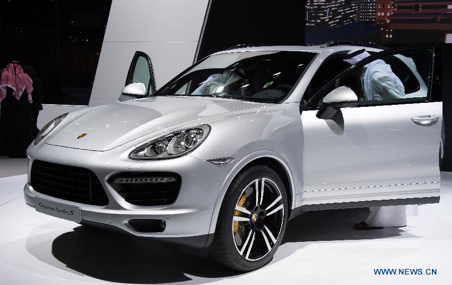 A visitor views a Porsche Cayenne Turbo S car during the 3rd Qatar International Auto Show held in Doha Exhibition Center, Qatar, on Jan. 28, 2013.The six-day Auto Show kicked off here on Monday. (Xinhua/Chen Shaojin)