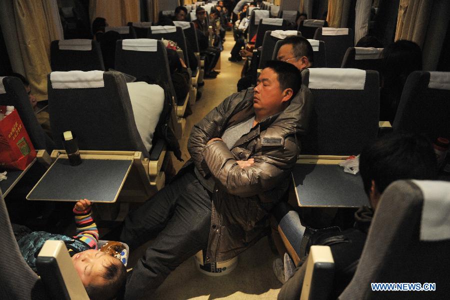 Passengers sleep on the train L8600 from Hangzhou, capital of east China's Zhejiang Province, to Fuyang, east China's Anhui Province, Jan. 29, 2013. The 40-day Spring Festival travel rush started on Jan. 26. The Spring Festival, which falls on Feb. 10 this year, is traditionally the most important holiday of the Chinese people. It is a custom for families to reunite in the holiday, a factor that has led to massive seasonal travel rushes in recent years as more Chinese leave their hometowns to seek work elsewhere. Public transportation is expected to accommodate about 3.41 billion travelers nationwide during the holiday, including 225 million railway passengers.(Xinhua/Huang Zongzhi) 